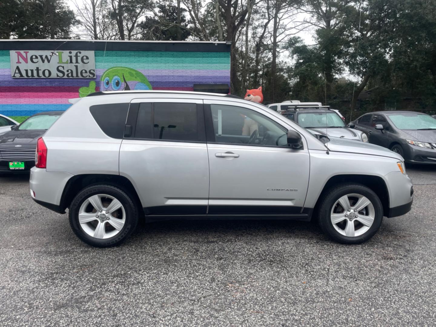 2012 SILVER JEEP COMPASS SPORT (1C4NJCBA8CD) with an 2.0L engine, Continuously Variable transmission, located at 5103 Dorchester Rd., Charleston, SC, 29418-5607, (843) 767-1122, 36.245171, -115.228050 - Spacious Interior with CD/AUX/AM/FM, Hands-free Phone, Power Windows, Power Locks, Power Windows, Power Mirrors, Keyless Entry, Alloy Wheels. Local Trade-in!! 108k miles Located at New Life Auto Sales! 2023 WINNER for Post & Courier's Charleston's Choice Pre-owned Car Dealer AND 2018-2024 Top 5 Fin - Photo#7